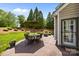 This outdoor patio features patio furniture, manicured landscaping, and elegant backyard at 1900 Birchbrook Ct, Harrisburg, NC 28075