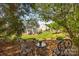 This is a large backyard featuring a patio, manicured landscaping and a grassy lawn at 1900 Birchbrook Ct, Harrisburg, NC 28075
