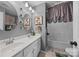 Bathroom featuring a dual sink vanity, decorative mirrors and a shower tub at 1900 Birchbrook Ct, Harrisburg, NC 28075
