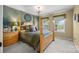 Cozy bedroom featuring a four-poster bed, decorative pillows, and natural light from the windows at 1900 Birchbrook Ct, Harrisburg, NC 28075