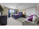 Comfortable bedroom with a ceiling fan, sofa, and ample natural light from the window at 1900 Birchbrook Ct, Harrisburg, NC 28075