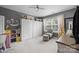 Bright bedroom features built-in storage, desk, and accent chair with lots of natural light at 1900 Birchbrook Ct, Harrisburg, NC 28075