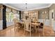 Formal dining room featuring a chandelier, hardwood floors, and a wooden table with seating for six at 1900 Birchbrook Ct, Harrisburg, NC 28075