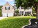 Lovely two-story home with a well-kept lawn, trimmed hedges, and an attached two-car garage at 1900 Birchbrook Ct, Harrisburg, NC 28075