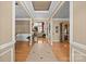 Inviting foyer with hardwood floors and elegant trim work, offering a view of the living spaces beyond at 1900 Birchbrook Ct, Harrisburg, NC 28075