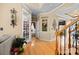 Charming entryway showcases hardwood floors, elegant trim, and a glimpse into adjacent living spaces at 1900 Birchbrook Ct, Harrisburg, NC 28075
