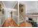 Hallway featuring hardwood flooring, a staircase, and trim at 1900 Birchbrook Ct, Harrisburg, NC 28075