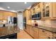 Gourmet kitchen features custom cabinetry, granite countertops, and stainless steel appliances, ideal for cooking at 1900 Birchbrook Ct, Harrisburg, NC 28075