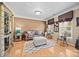 Cozy living room with hardwood floors, a comfortable sofa, and bright windows offering natural light at 1900 Birchbrook Ct, Harrisburg, NC 28075