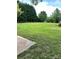 Expansive green backyard surrounded by lush trees offering serene outdoor space at 2030 Keisler Dairy Rd, Conover, NC 28613