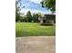 Large, grassy backyard with an outbuilding featuring a deck and stairs at 2030 Keisler Dairy Rd, Conover, NC 28613