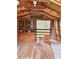 Interior space with wooden walls and flooring, featuring furniture, a window, and natural light at 2030 Keisler Dairy Rd, Conover, NC 28613