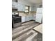 Bright kitchen featuring stainless steel appliances, painted cabinets and wood-look floors at 2030 Keisler Dairy Rd, Conover, NC 28613