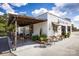 Charming white brick commercial building featuring a cozy outdoor seating area with pergola cover and string lights at 2049 Stephens Farm Dr, China Grove, NC 28023