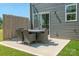 Back patio features dark wicker chairs, table, and sliding glass door with dark siding at 2049 Stephens Farm Dr, China Grove, NC 28023
