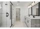 Bathroom features a glass-enclosed shower, dual sink vanity with modern fixtures, and marble-look tile flooring at 2176 Millennium Dr # 093, Lancaster, SC 29720