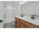 Bathroom featuring dual sinks, wood cabinetry, modern fixtures, a tiled shower/tub and gray hexagonal tile flooring at 2176 Millennium Dr # 093, Lancaster, SC 29720