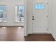 Bright entryway featuring wood floors, white trim, and a door with glass panel allowing for natural light to fill the foyer at 2176 Millennium Dr # 093, Lancaster, SC 29720