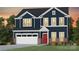 Charming new construction two-story home featuring a brick-accented facade, attached garage and inviting red front door at 2176 Millennium Dr # 093, Lancaster, SC 29720