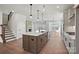 Spacious open-concept kitchen with large center island, modern appliances, hardwood floors and brick fireplace at 2176 Millennium Dr # 093, Lancaster, SC 29720