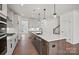Open-concept kitchen featuring a spacious island with seating, stainless steel appliances, and modern cabinetry at 2176 Millennium Dr # 093, Lancaster, SC 29720