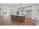 Well-lit kitchen featuring hardwood floors, large center island with bar seating and sleek stainless steel appliances at 2176 Millennium Dr # 093, Lancaster, SC 29720