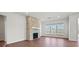 Bright living room featuring hardwood floors, a brick fireplace, and large windows at 2176 Millennium Dr # 093, Lancaster, SC 29720