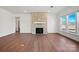 Living room featuring hardwood floors, a brick fireplace and three large bright windows at 2176 Millennium Dr # 093, Lancaster, SC 29720