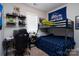 This cozy bedroom features a bunk bed, desk, and shelving with various toys and decorations at 2205 Philadelphia Church Rd, Dallas, NC 28034