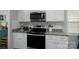 Modern kitchen features stainless steel appliances, granite countertops, and white cabinetry at 2205 Philadelphia Church Rd, Dallas, NC 28034
