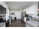 Modern kitchen featuring white cabinets, stainless steel appliances, and granite countertops at 2205 Philadelphia Church Rd, Dallas, NC 28034