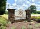 Stone and brick entrance to Rolling Hills Country Club with manicured landscaping at 2512 Mabel Ln, Monroe, NC 28110