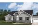 Charming one-story home with stone accents, neutral siding, and well-manicured lawn at 2512 Mabel Ln, Monroe, NC 28110