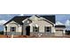 Charming new construction home featuring stone accents, black shutters, and a stylish garage door at 2512 Mabel Ln, Monroe, NC 28110