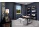 A sophisticated home office featuring dark walls, a large window, and built-in shelving, creating an inspiring workspace at 2512 Mabel Ln, Monroe, NC 28110