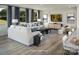 Bright living room featuring a comfortable white sofa, stylish decor, large windows with backyard views at 2512 Mabel Ln, Monroe, NC 28110