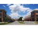 Commercial street with retail buildings, parking spaces, and lush green trees at 2512 Mabel Ln, Monroe, NC 28110