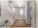 Bright foyer features wood-look floors, a staircase, and a view of the front door with glass panel at 2526 Mabel Ln, Monroe, NC 28110