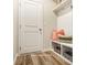Inviting entryway with a built-in bench, shelving, and luxury vinyl plank flooring at 2526 Mabel Ln, Monroe, NC 28110