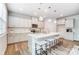 Modern kitchen featuring white cabinets, a large island with seating, and stainless steel appliances at 2526 Mabel Ln, Monroe, NC 28110