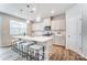 Bright kitchen with a center island, modern lighting, and a view of the stainless steel appliances at 2526 Mabel Ln, Monroe, NC 28110