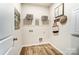 This laundry room features shelving, storage hooks, and luxury vinyl plank flooring at 2526 Mabel Ln, Monroe, NC 28110