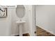 This powder room features a pedestal sink, oval mirror and hardwood style flooring at 2901 Penninger Cir, Charlotte, NC 28262