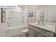 Bright bathroom featuring a tub and shower combination and a gray vanity with a white countertop at 2913 Penninger Cir, Charlotte, NC 28262