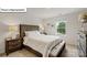 This bedroom includes a queen bed, bench and bright window looking out to the backyard at 2913 Penninger Cir, Charlotte, NC 28262