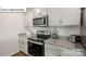 Updated kitchen with gray cabinets, granite countertops, and stainless-steel appliances, perfect for cooking at 2917 Penninger Cir, Charlotte, NC 28262