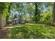 Expansive backyard featuring a hot tub, brick patio, and outdoor seating, perfect for relaxation and entertaining at 2933 Hilliard Dr, Charlotte, NC 28205