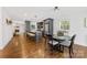 Open kitchen and dining area with a large center island, hardwood floors, and modern fixtures at 2933 Hilliard Dr, Charlotte, NC 28205