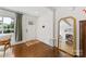 Bright foyer showcasing hardwood floors, a statement mirror, and a white front door with glass panels at 2933 Hilliard Dr, Charlotte, NC 28205