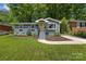 Charming single-story home featuring a well-maintained lawn, landscaped garden beds, and inviting front steps at 2933 Hilliard Dr, Charlotte, NC 28205
